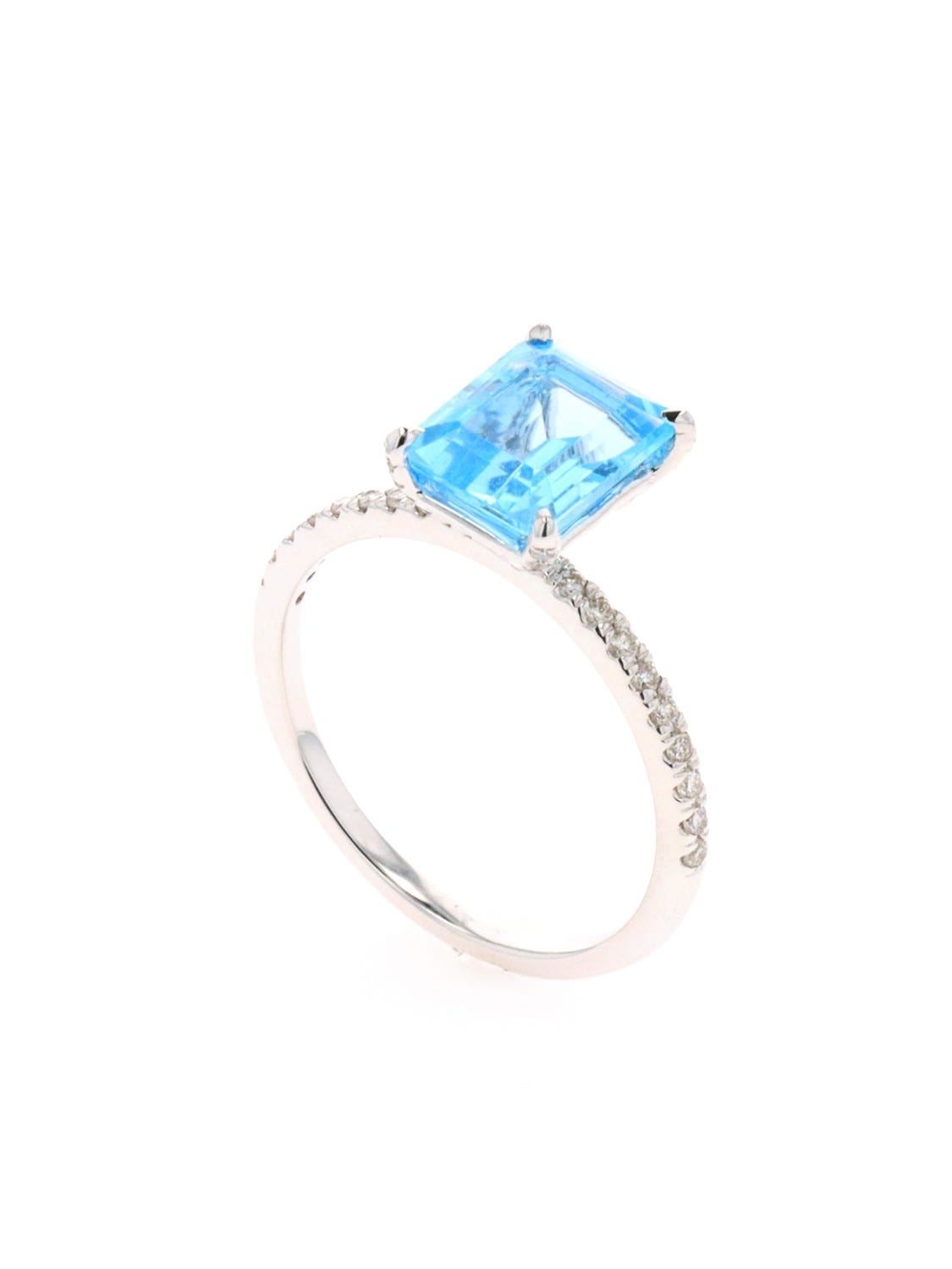 Anillo de oro blanco 14k con 25 pts de diamante y topacio azul