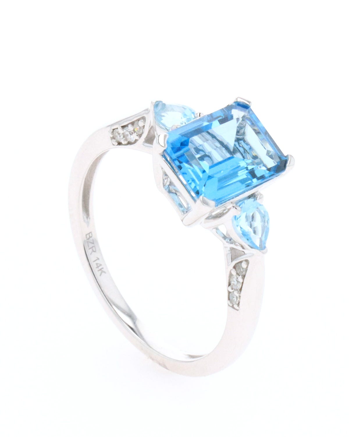 Anillo de oro blanco 14k con 10 pts de diamante y topacio azul
