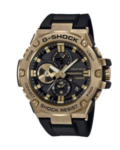 Reloj Casio G-Shock, para caballero, resistencia a impactos, bisel de metal chapado en oro sobre una base negra.
